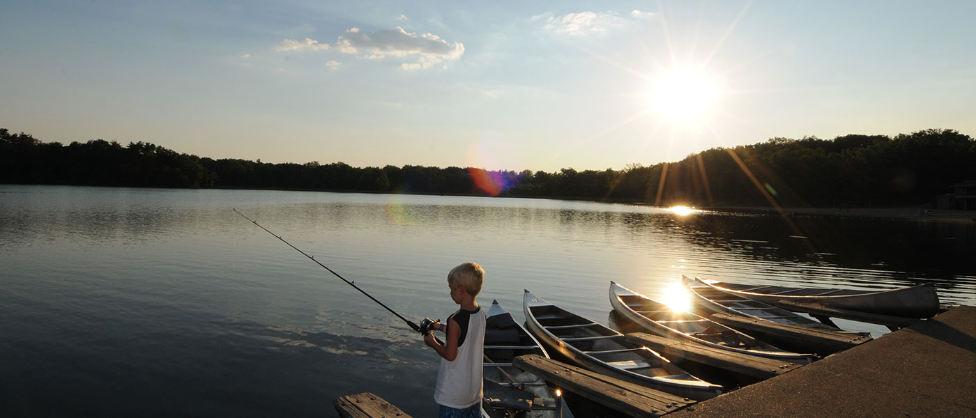 boy fishing at sunset