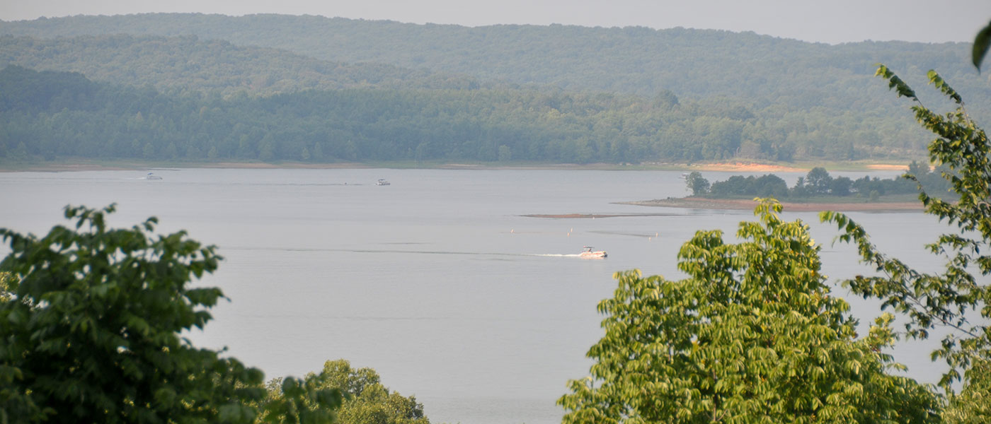 view of the lake with hills in the distance