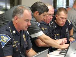 Police officers work with a JTAC developer to test the eCWS system and provide feedback about the equipment, the online application and the tickets it produces.