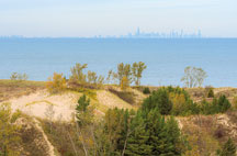 The Chicago skyline along the shore of Lake Michigan as seen from atop a dune along Paul H. Douglas Trail.