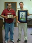 Chris Hostettler accepts an award from Division of Reclamation Director Bruce Stevens