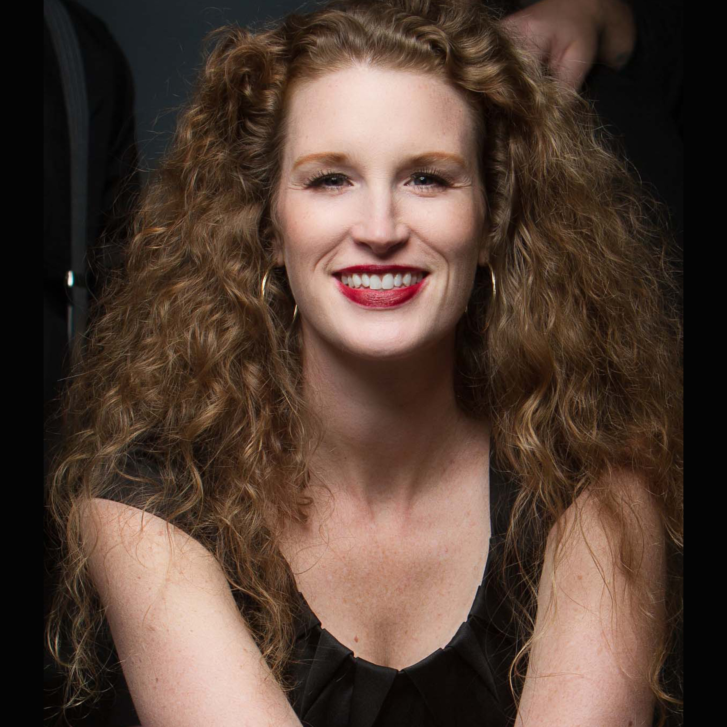 Image of woman with brown curly hair