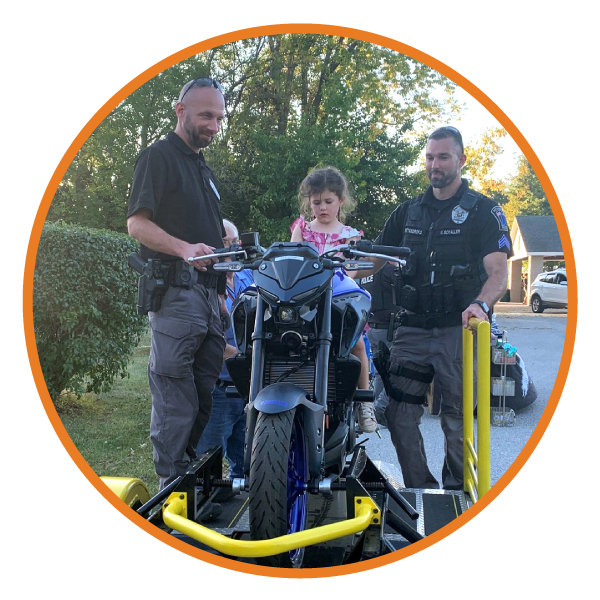 Young girl sitting on the RSI training motorcycle