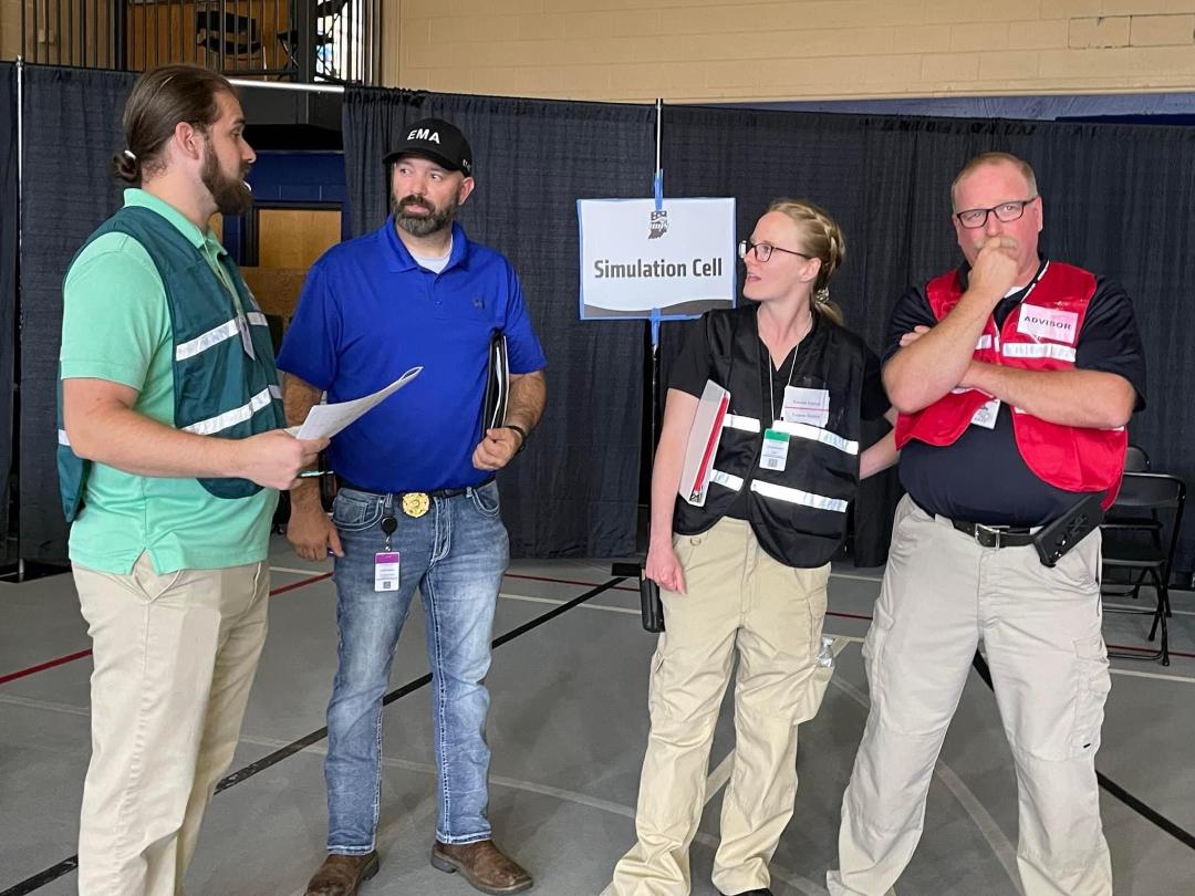Noble County EMA Director Justin Stump (second from left) discusses injects with members of IDHS. 