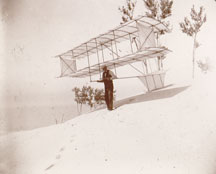 Chanute holds his biplane glider with side panels in August 1896 (Chanute photo album, Manuscript Division, Library of Congress).