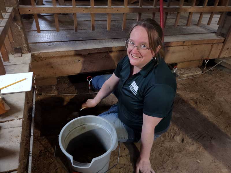 Woman on ground sorting soil