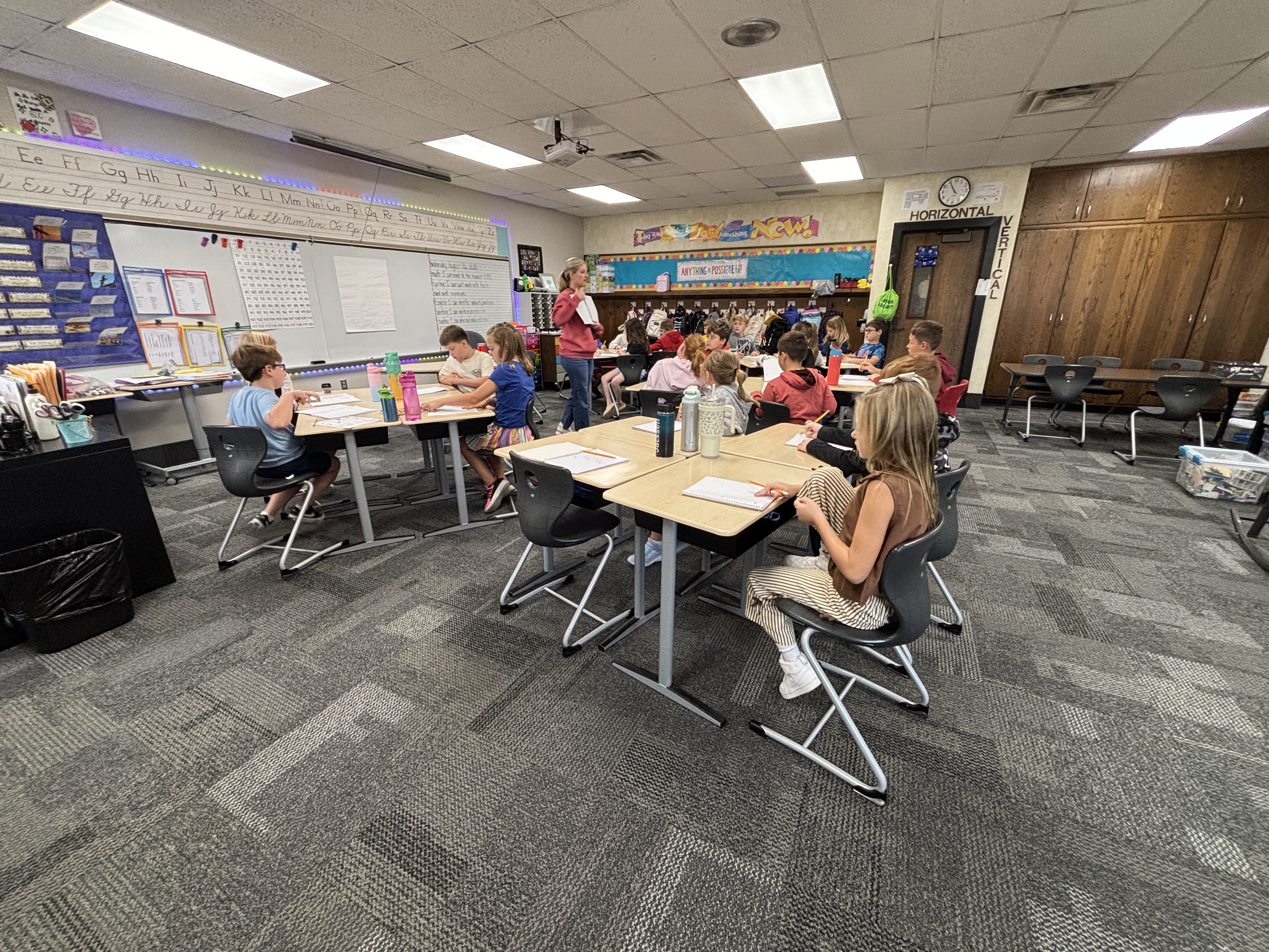Students giving their attention to the teacher as instructions are given.