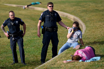 Law enforcement officers stand by injured people