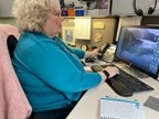 A person working on a computer  Description automatically generated with low confidence