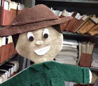 Felt figure in front of files