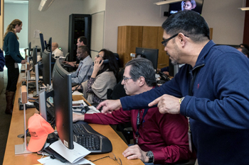 EOC workers at bank of computers