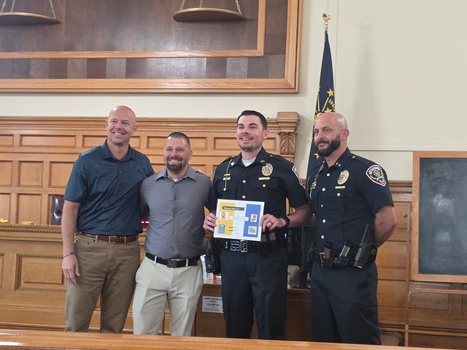 DCS Director Adam Krupp and Blackford County Local Office Director Ryan Jacobs stand with Sergeant Tyler Capper.