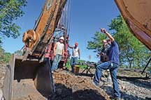 DNR Oil & Gas Program manager Brian Royer joins the plugging crew to measure the depth of the well&rsquo;s cement plug.   