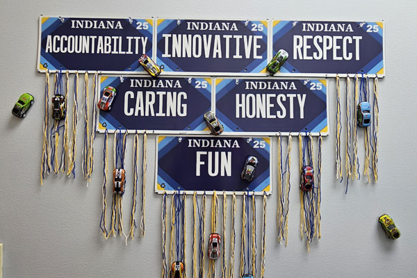 Wall display of BMV's Core Values with Hot Wheels cars
