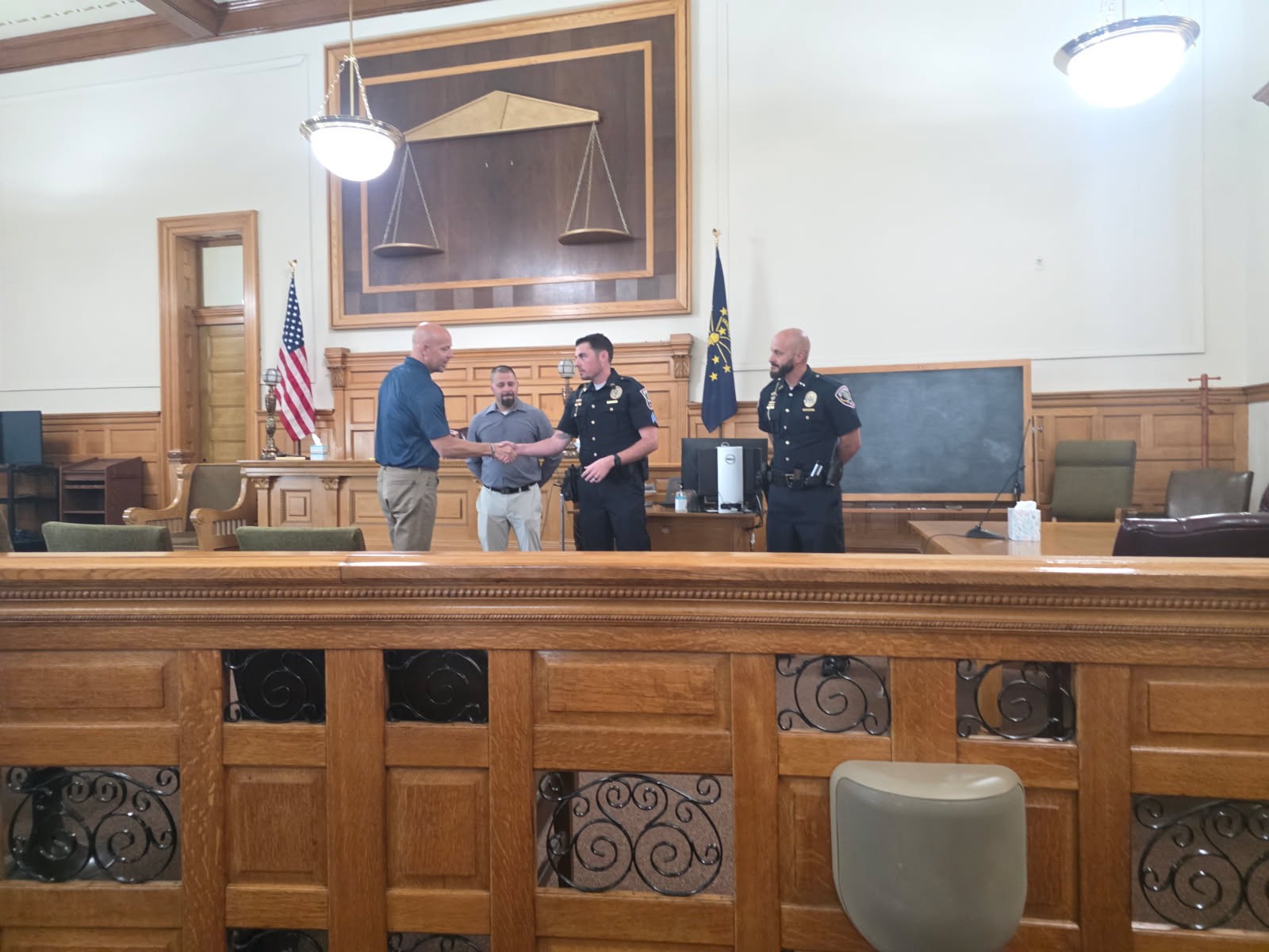 Adam Krupp gives a challenge coin to Hartford City Police Sargeant Tyler Capper