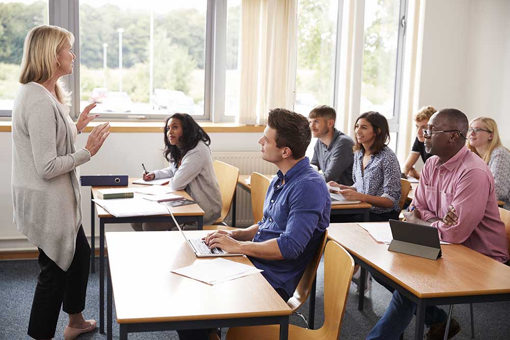 Teacher speaking in front of Adult Learners