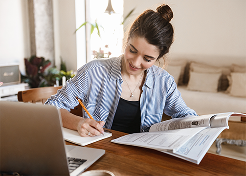 person taking notes at a desk