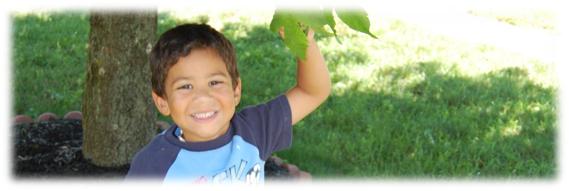 picture of a happy boy under a tree