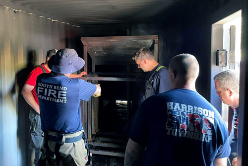 Firefighters talk inside Corydon training facility