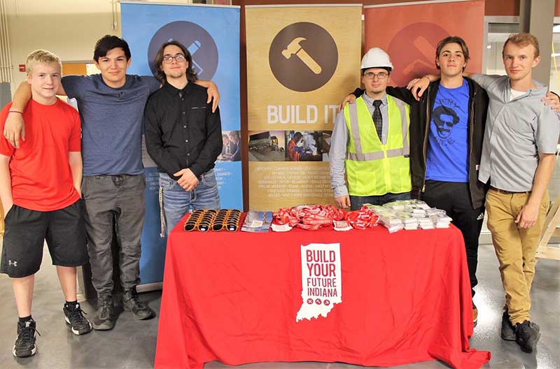 Hamilton Heights students posing for a picture at a Conference table/booth for Build Your Future Indiana