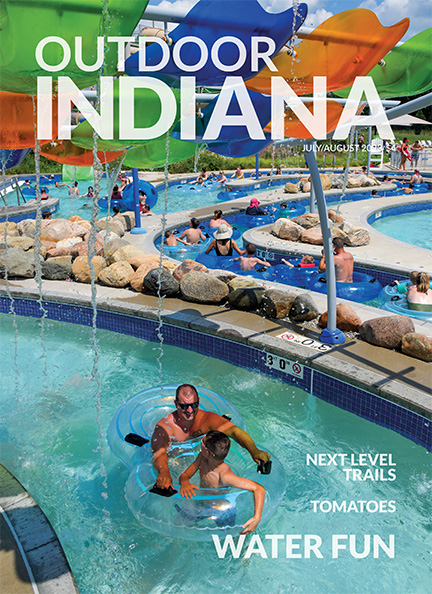 Michael Beasley of Bremen and his son Owen, 9, keep cool in the lazy river at the aquatic center at Prophetstown State Park. Photo by Brent Drinkut.
