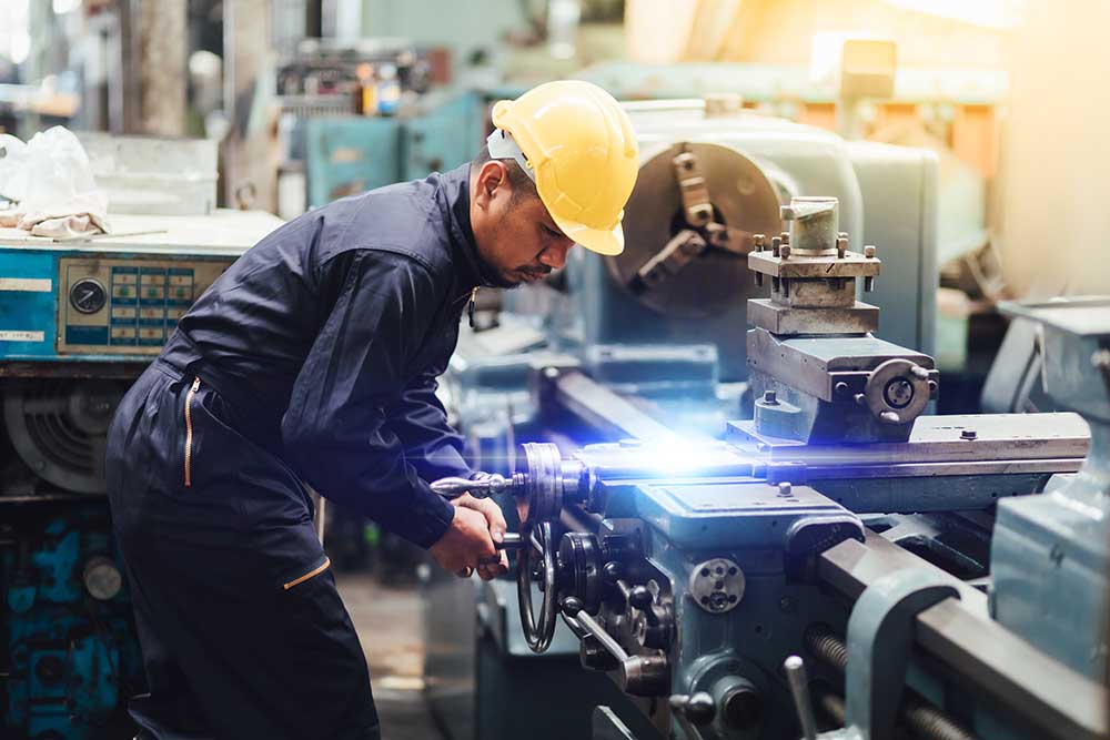 Image of man using a high precision machining tool