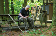 Mark Lods strips the bark off what will eventually become a walking stick.