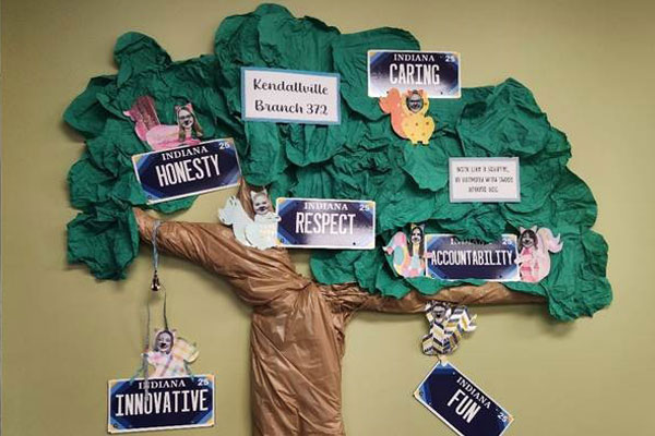 Wall display of BMV's Core Values with a tree and squirrels