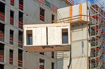 Modular structure being lifted by crane