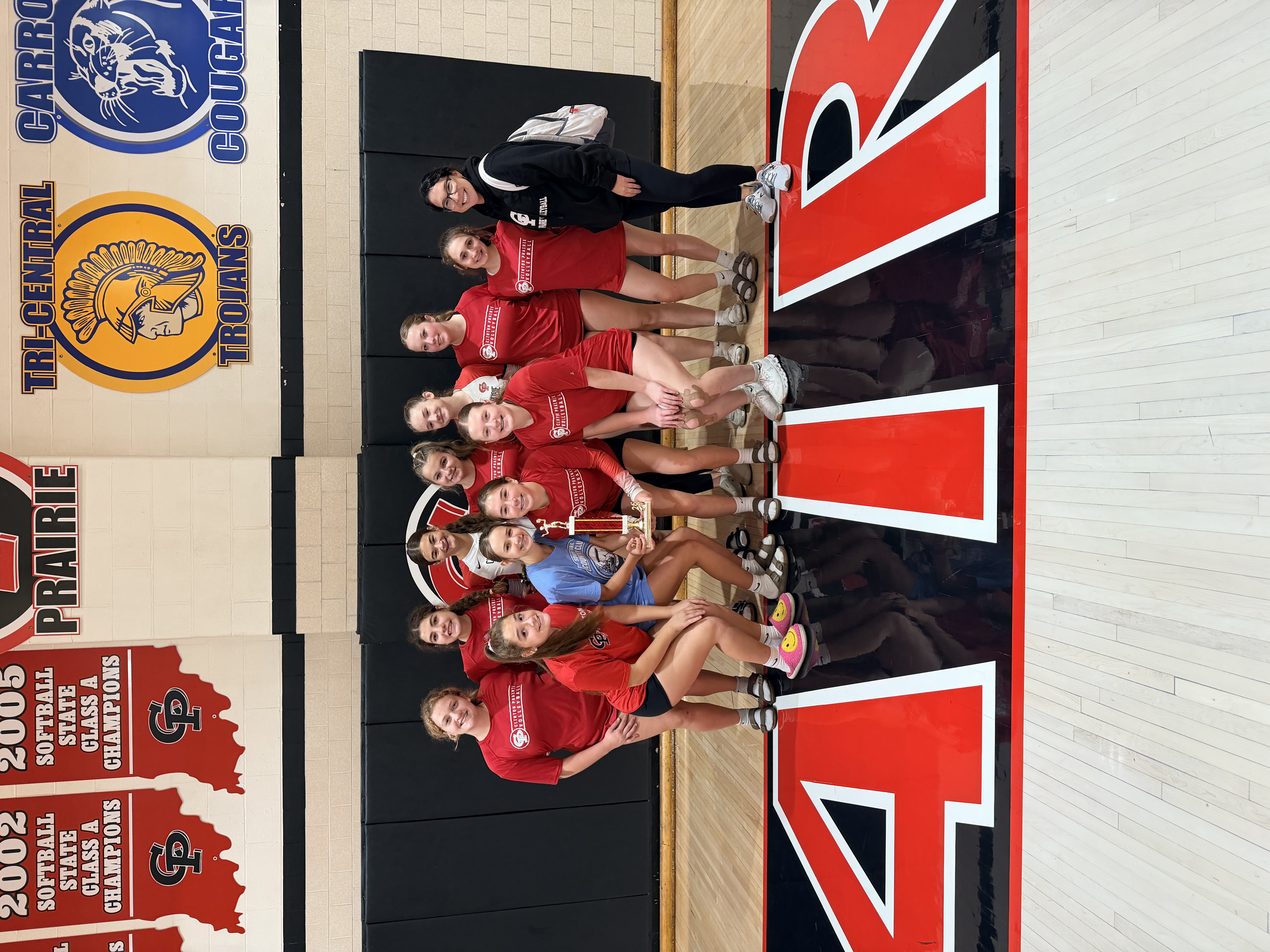 Clinton Prairie junior volleyball girls pose with their trophy after winning the annual volleyball invitational.