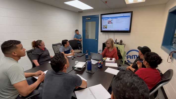 Teacher educating students via digital monitor