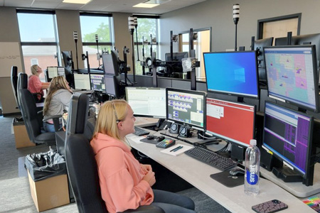 Telecommunicators in dispatch center Telecommunicators in dispatch center