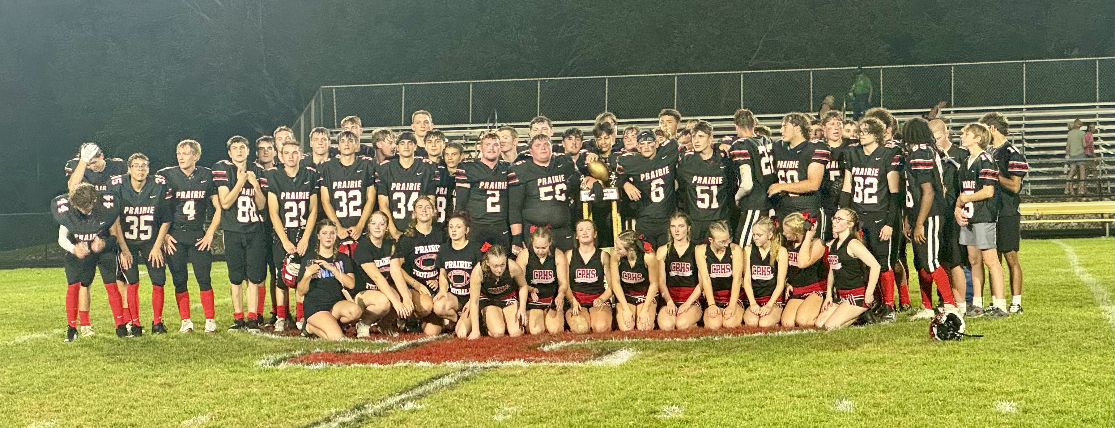 Clinton Prairie Football and Cheerleaders pose for a photo after winning the annual Corn Bowl football game.