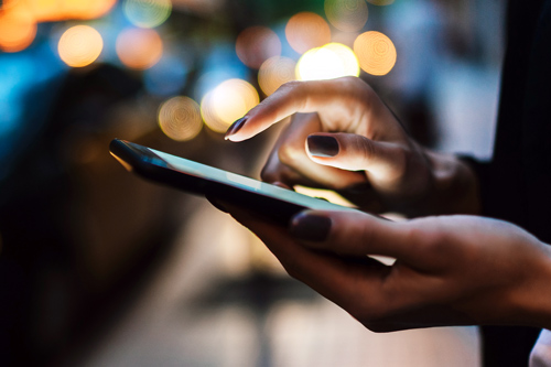 Woman holding cell phone in hands