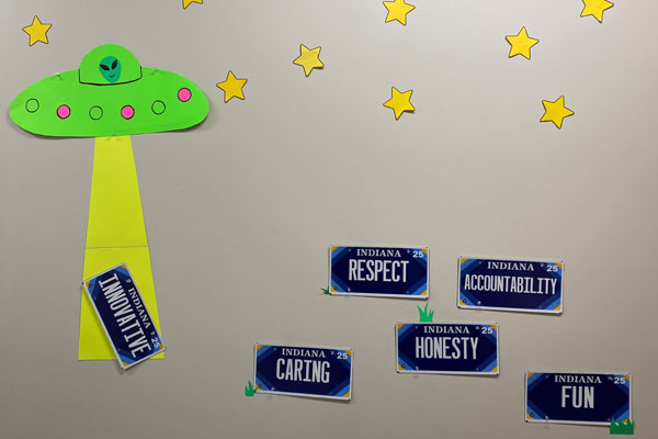 Wall display of BMV's Core Values with a spaceship and aliens