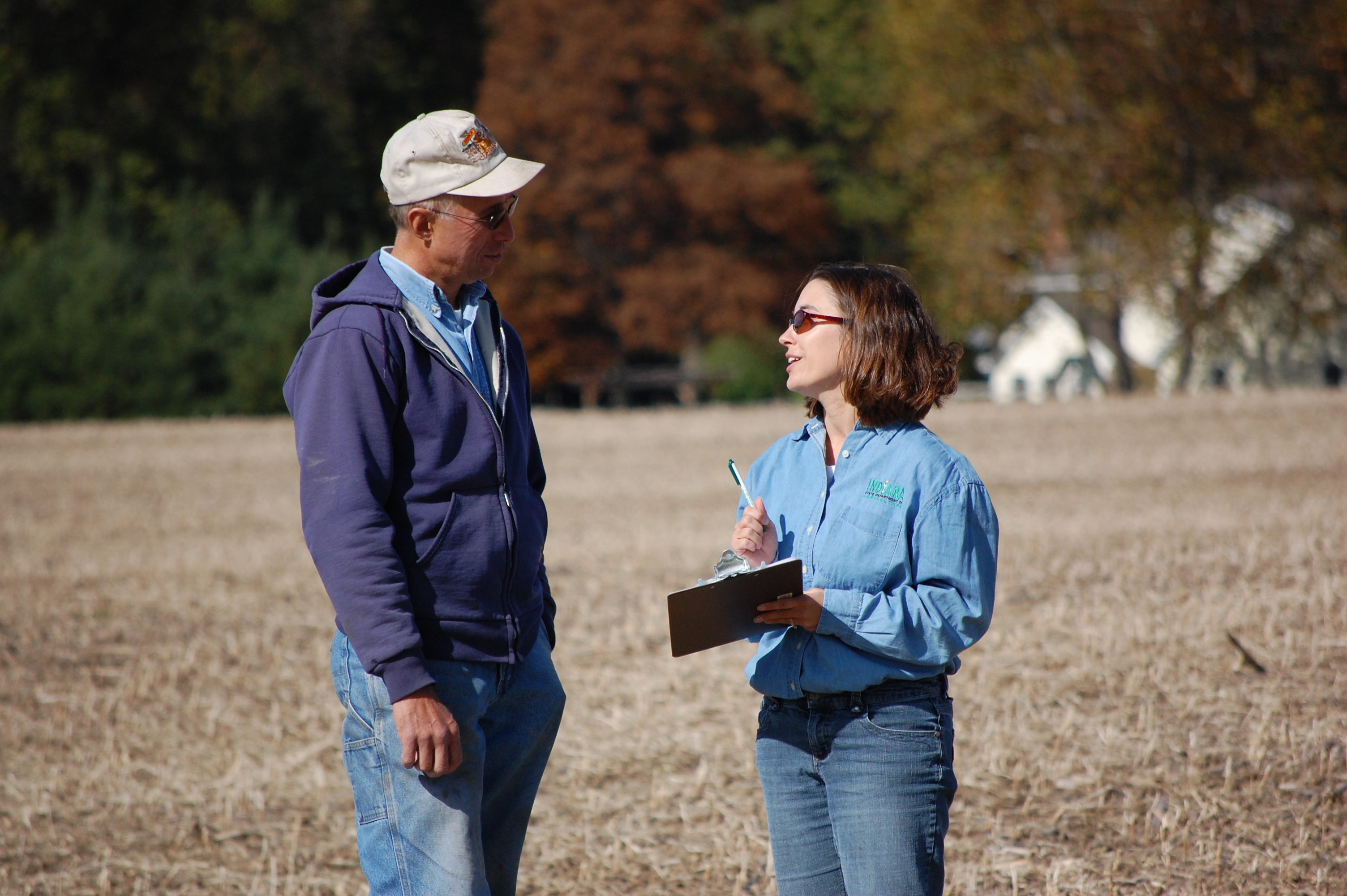 A technncian provides a consultation to a farmer