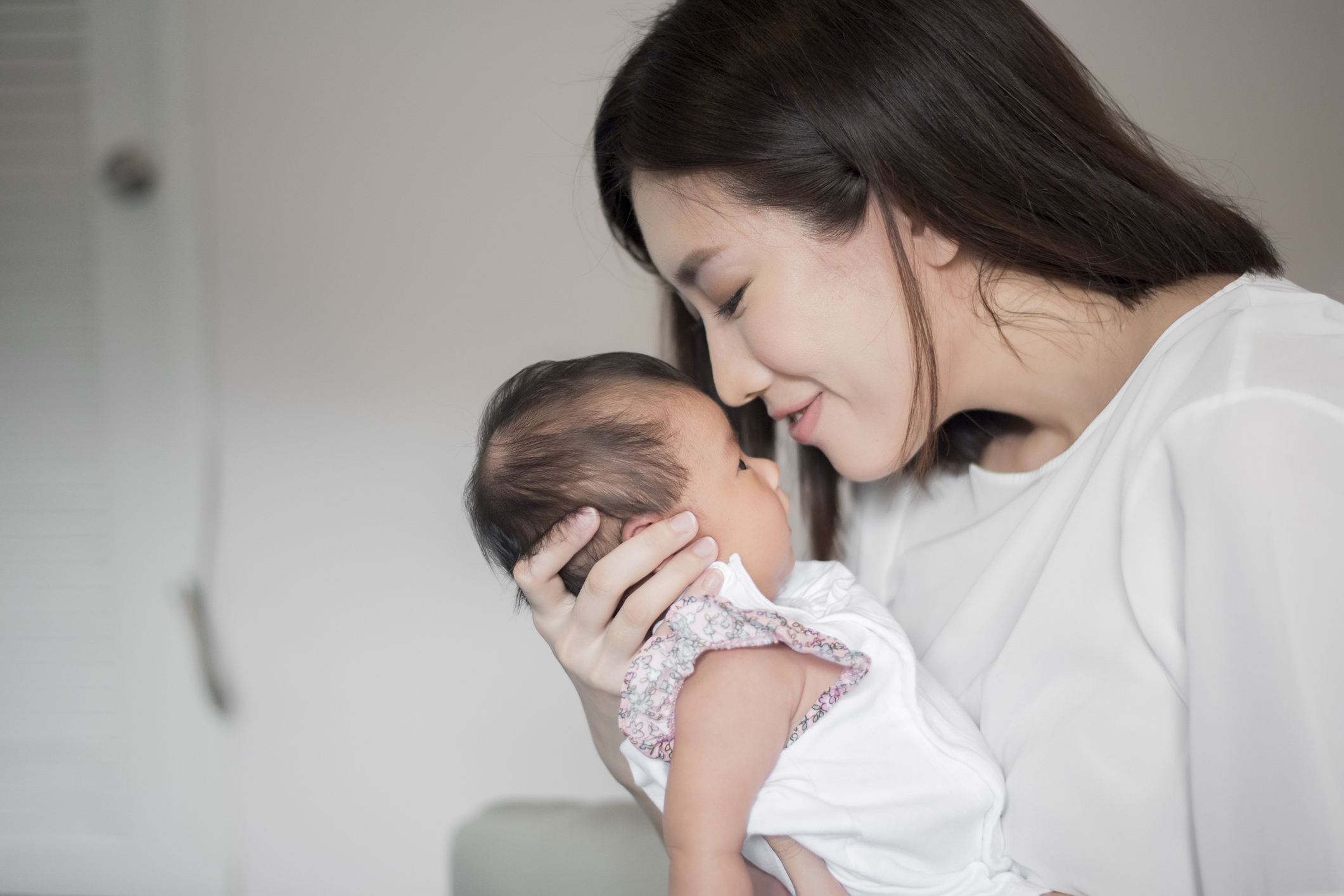 mom holding baby mom and baby
