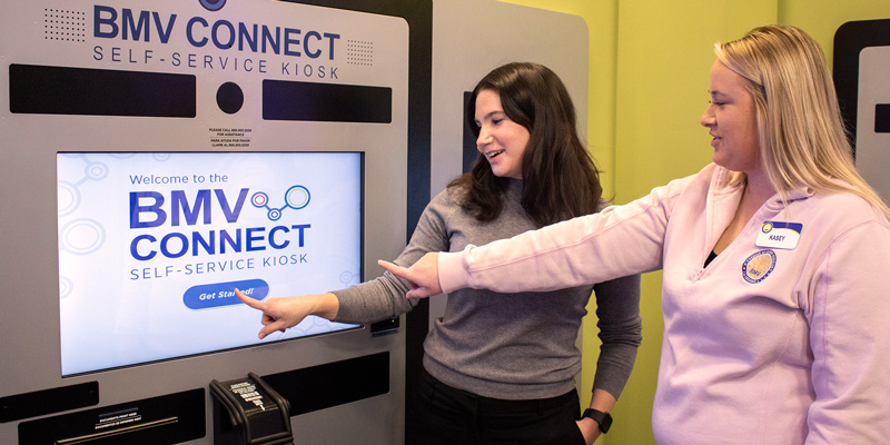 BMV team lead showing a customer how to use the Connect kiosk