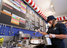
Cathy Brown decorates a Valpo Velvet ice cream cake. (Above) Colorful ice cream cones at Valpo Velvet. Brent Drinkut photo.
  