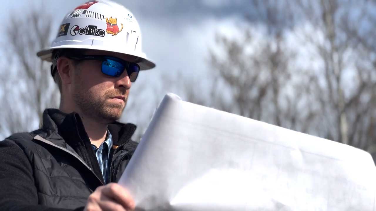Construction worker reviewing blueprints