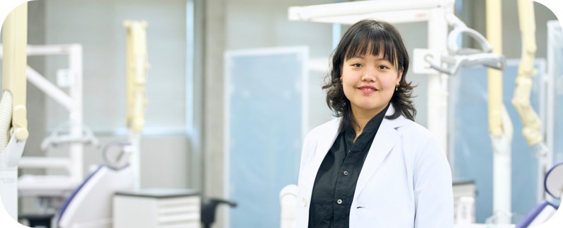 A person in a lab coat standing in a lab