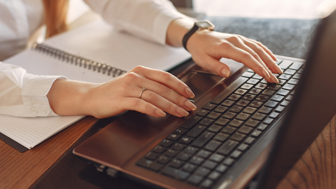 Person typing on laptop