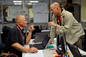 EOC workers discuss at table