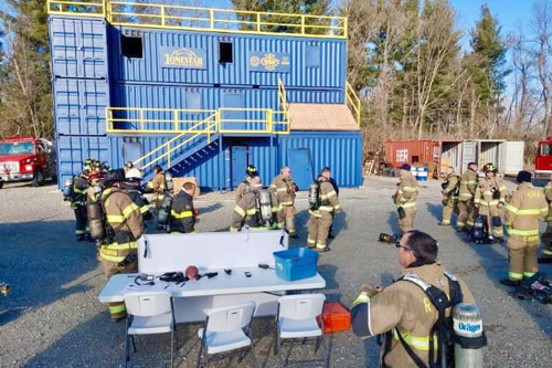 Group of firefighters surround Hub-and-Spoke training facility in Wabash