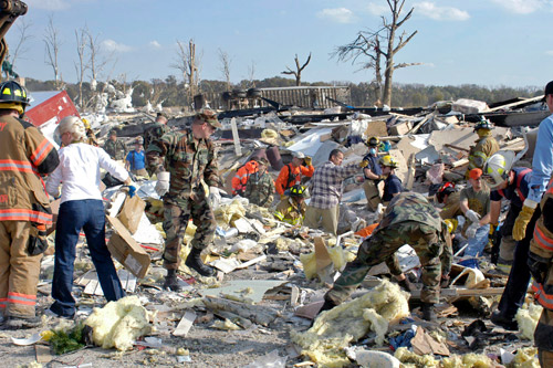 First responders and residents searching tornado debris