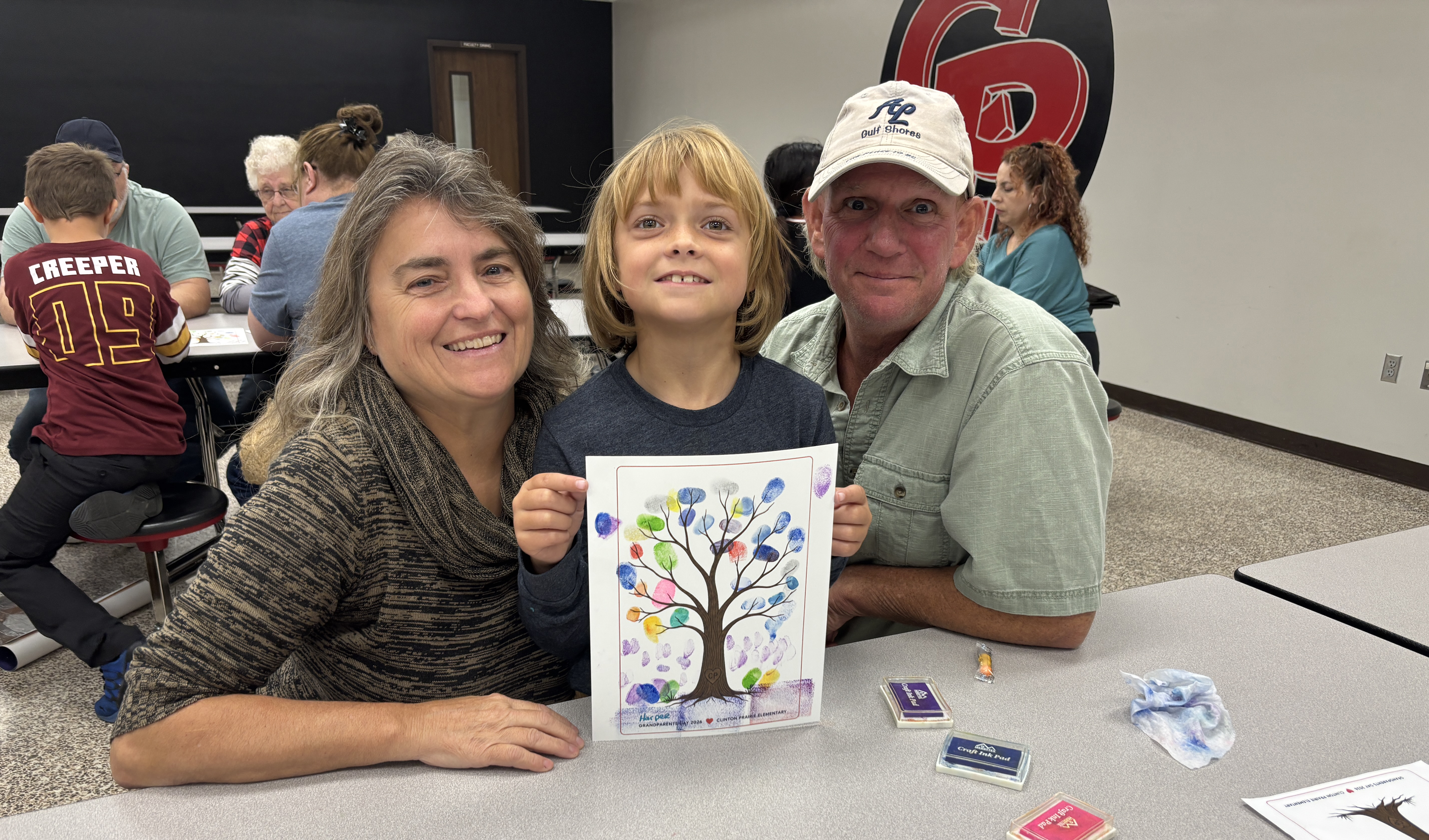Student and Grandparents pose with their craft.