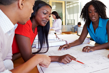 Group of architects looking at building plans