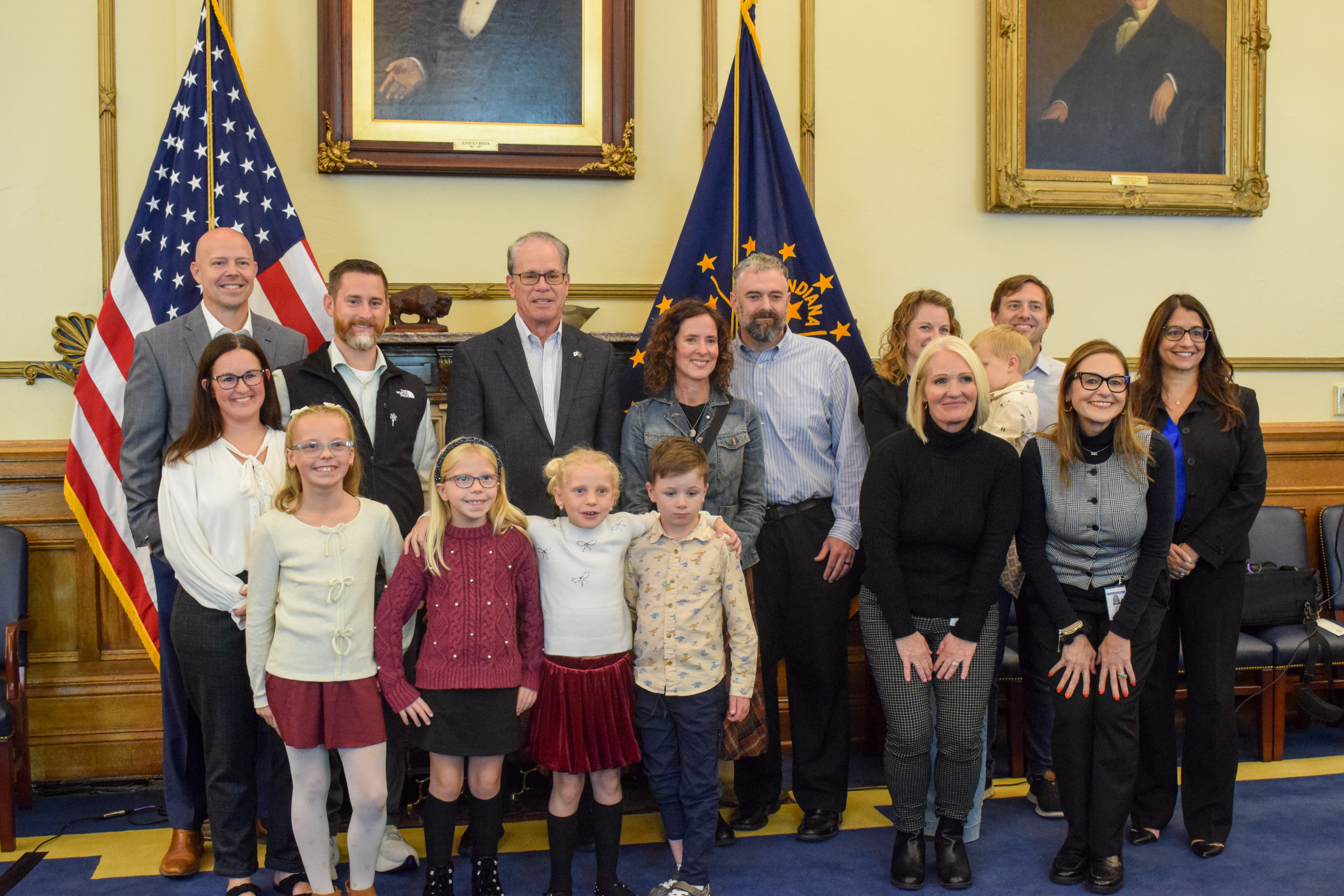 Gov. Braun and DCS staff gather with adoptive families for a group photo.