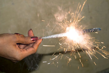Lit sparkler firework in a hand