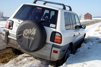 Car stuck in snow on roadside